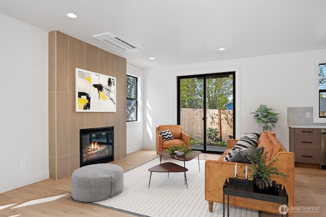 1831 4th St Unit A, Kirkland, WA 98033 - living area with a glass covered fireplace, light wood-style flooring, baseboards, and recessed lighting