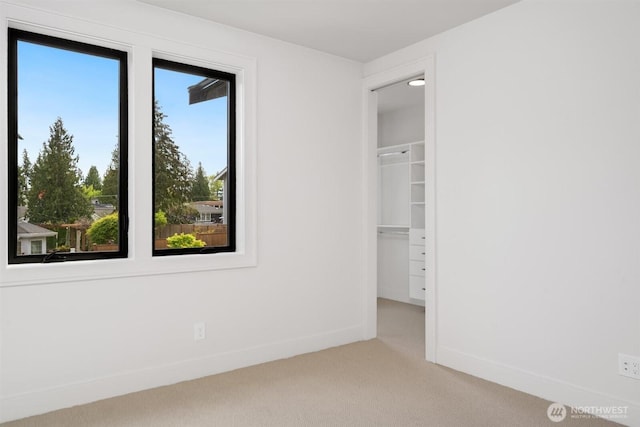 1831 4th St Unit A, Kirkland, WA 98033 - unfurnished bedroom with carpet, baseboards, a spacious closet, and a closet