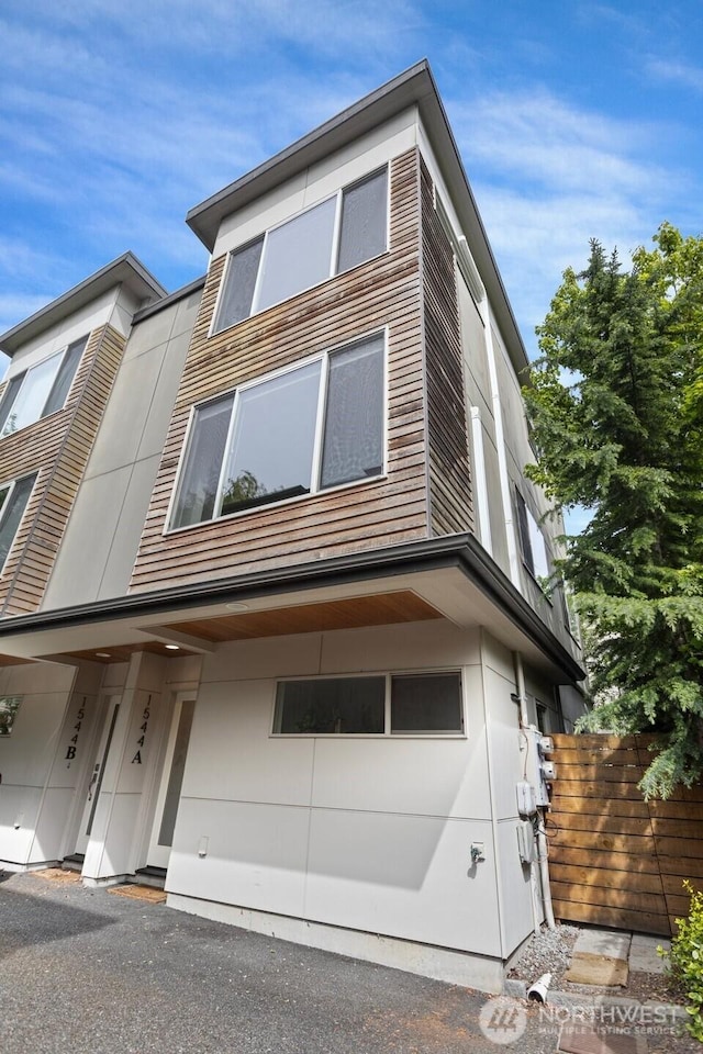 modern home featuring fence