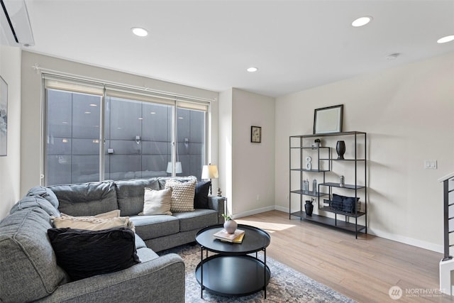 living area with wood finished floors, baseboards, and recessed lighting