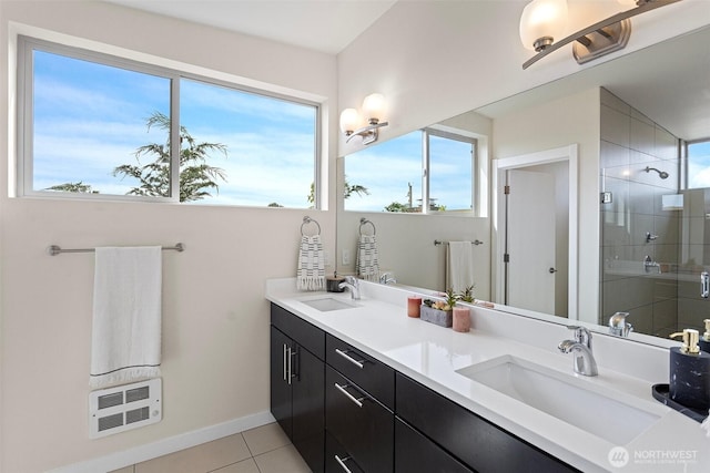 full bathroom featuring a stall shower, tile patterned floors, double vanity, heating unit, and baseboards