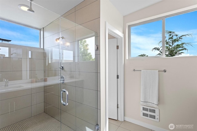bathroom with plenty of natural light, a stall shower, and tile patterned floors