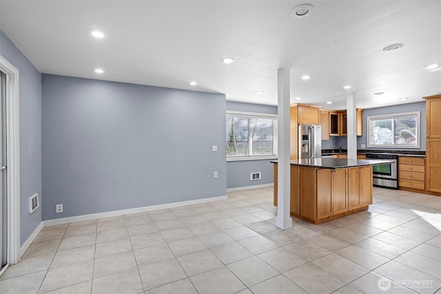 1526 192nd St SE Unit P4, Bothell, WA 98012 - kitchen with stainless steel appliances, healthy amount of natural light, recessed lighting, light tile patterned flooring, and baseboards