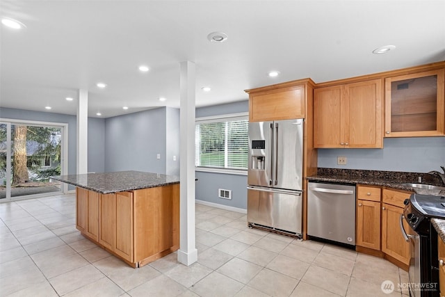 1526 192nd St SE Unit P4, Bothell, WA 98012 - kitchen featuring appliances with stainless steel finishes, a sink, dark stone countertops, glass insert cabinets, and recessed lighting