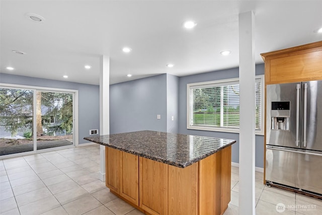 1526 192nd St SE Unit P4, Bothell, WA 98012 - kitchen with stainless steel fridge with ice dispenser, dark stone countertops, a center island, baseboards, and recessed lighting