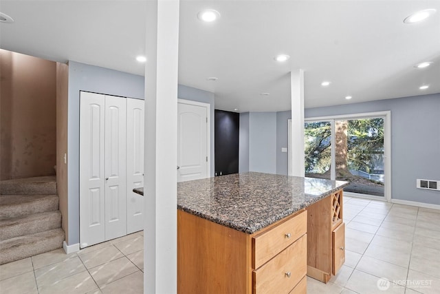 1526 192nd St SE Unit P4, Bothell, WA 98012 - kitchen with light tile patterned flooring, a center island, dark stone counters, baseboards, and recessed lighting