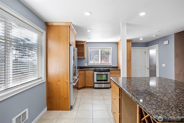 1526 192nd St SE Unit P4, Bothell, WA 98012 - kitchen with appliances with stainless steel finishes, light tile patterned floors, dark stone counters, recessed lighting, and baseboards