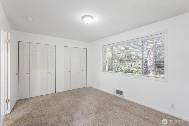 1526 192nd St SE Unit P4, Bothell, WA 98012 - unfurnished bedroom featuring multiple closets, carpet flooring, and baseboards