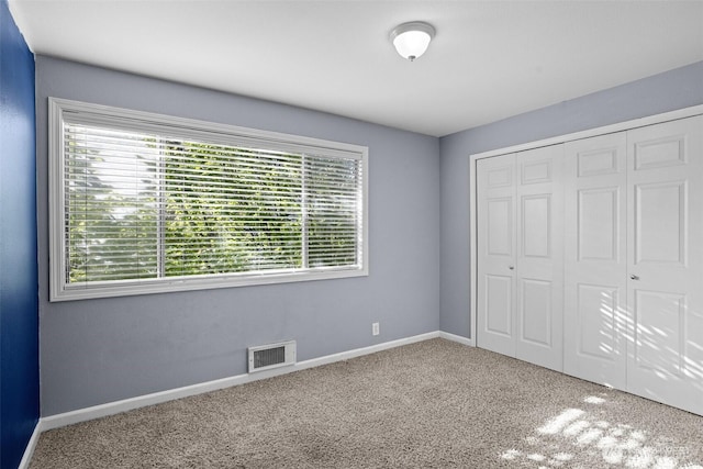 1526 192nd St SE Unit P4, Bothell, WA 98012 - unfurnished bedroom featuring multiple windows, carpet floors, a closet, and baseboards