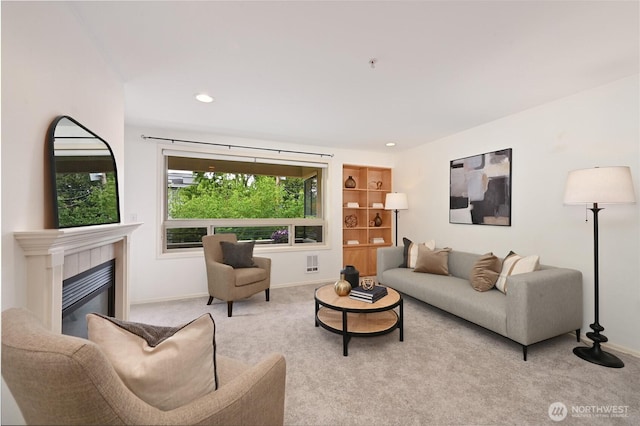 living area featuring carpet, a fireplace, baseboards, and recessed lighting