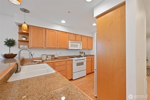 kitchen with white appliances, a sink, light countertops, open shelves, and decorative light fixtures