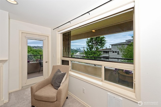 living area featuring carpet flooring and baseboards