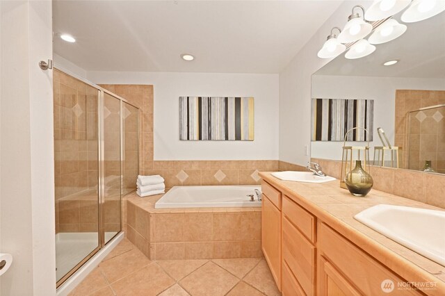 full bathroom with a stall shower, tile patterned floors, a garden tub, recessed lighting, and a chandelier
