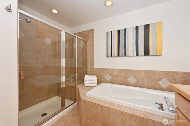 bathroom featuring a shower stall, a garden tub, and recessed lighting