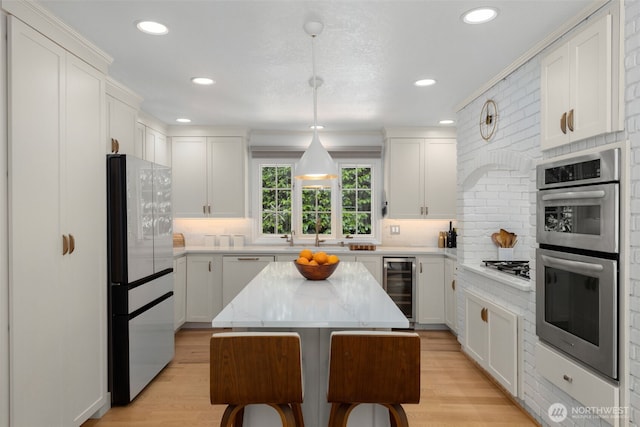 5222 W Mercer Way, Mercer Island, WA 98040 - kitchen featuring refrigerator, beverage cooler, double oven, backsplash, and recessed lighting