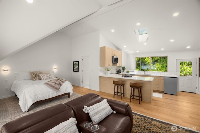 5222 W Mercer Way, Mercer Island, WA 98040 - bedroom with a skylight, a sink, recessed lighting, light wood-type flooring, and fridge