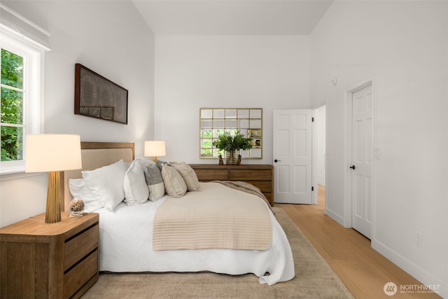 5222 W Mercer Way, Mercer Island, WA 98040 - bedroom featuring light wood-type flooring, multiple windows, and baseboards