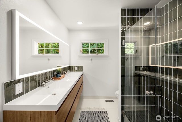 5222 W Mercer Way, Mercer Island, WA 98040 - full bathroom with double vanity, tiled shower, toilet, and baseboards