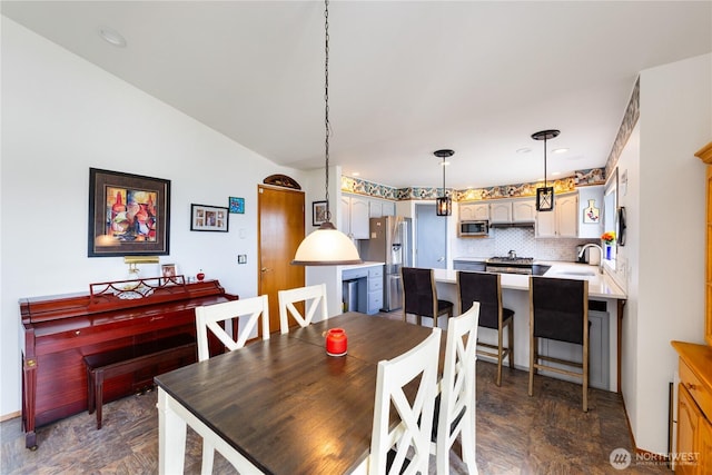 dining room featuring vaulted ceiling