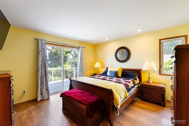 bedroom featuring access to outside, wood finished floors, baseboards, and recessed lighting