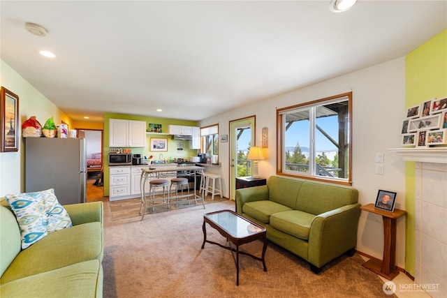 living room featuring recessed lighting and light carpet