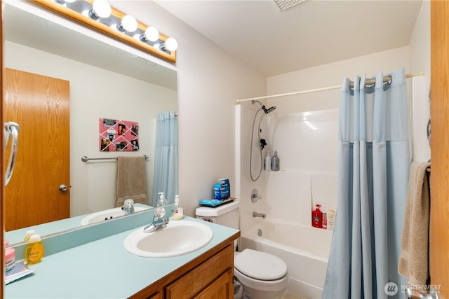 bathroom featuring vanity, shower / bath combo, and toilet