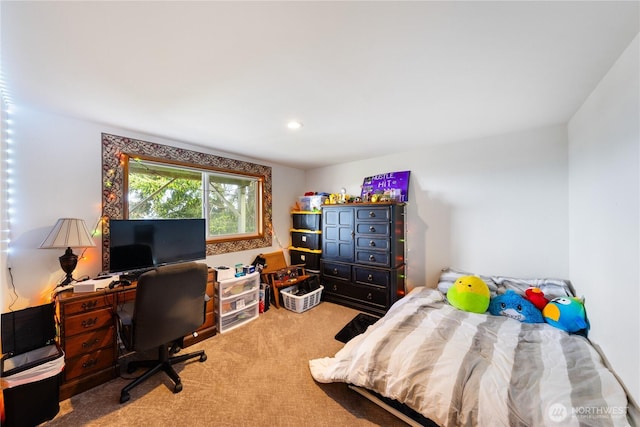 carpeted bedroom featuring a desk