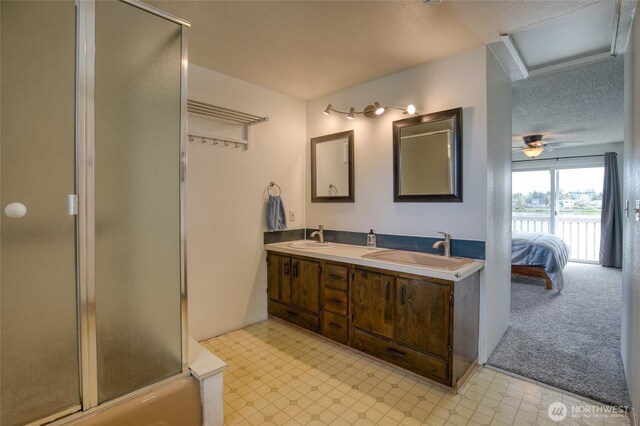 712 Mt Olympus Ave SE, Ocean Shores, WA 98569 - ensuite bathroom featuring an enclosed shower, double vanity, and tile patterned floors