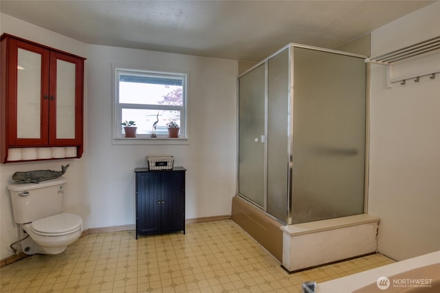 712 Mt Olympus Ave SE, Ocean Shores, WA 98569 - bathroom with tile patterned floors, a shower with door, toilet, baseboards, and a tub