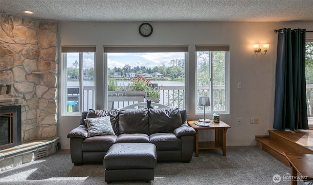 712 Mt Olympus Ave SE, Ocean Shores, WA 98569 - carpeted living area with healthy amount of natural light, a textured ceiling, and a fireplace