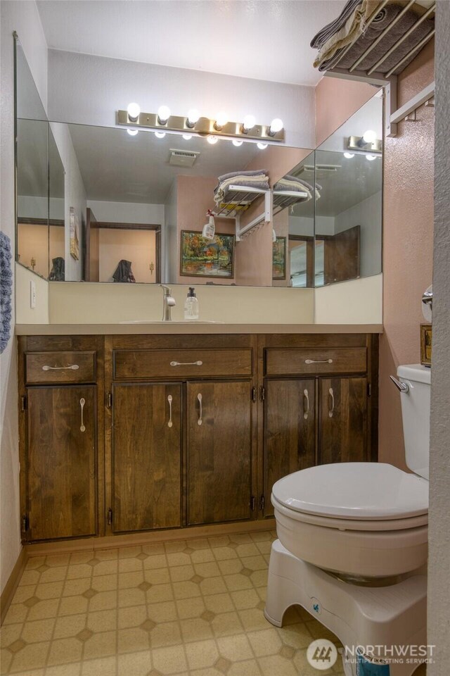 712 Mt Olympus Ave SE, Ocean Shores, WA 98569 - bathroom with toilet, tile patterned floors, and vanity