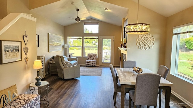 dining space featuring vaulted ceiling, dark wood finished floors, a ceiling fan, plenty of natural light, and baseboards