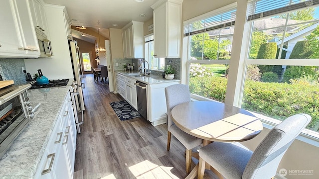 kitchen featuring a sink, tasteful backsplash, and white cabinets