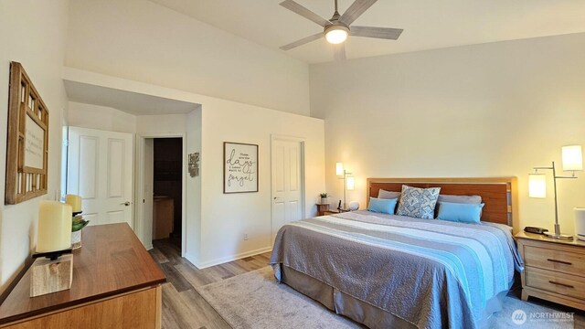 bedroom featuring wood finished floors, baseboards, and ceiling fan