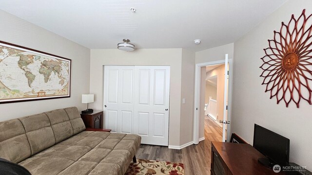 living area with dark wood finished floors, an office area, and baseboards