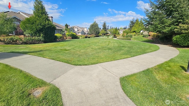 view of community featuring a lawn and a residential view
