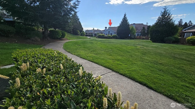 view of home's community featuring a lawn