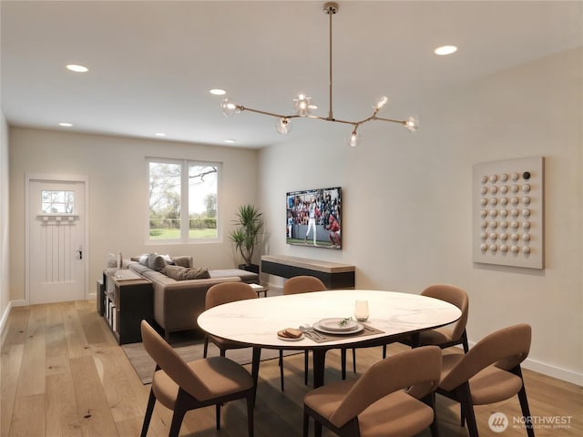 dining space with baseboards, recessed lighting, a chandelier, and light wood-style flooring