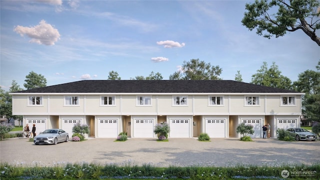 view of front of house featuring gravel driveway and a garage