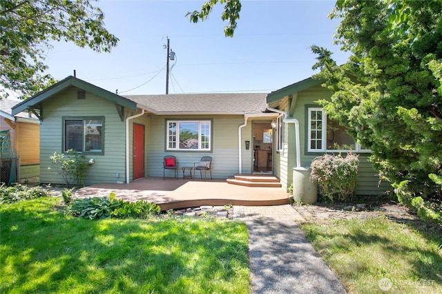 2721 Iron St, Bellingham, WA 98225 - view of front of house featuring a front yard, roof with shingles, and a wooden deck