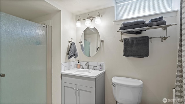 bathroom featuring tasteful backsplash, a shower with shower curtain, toilet, and vanity