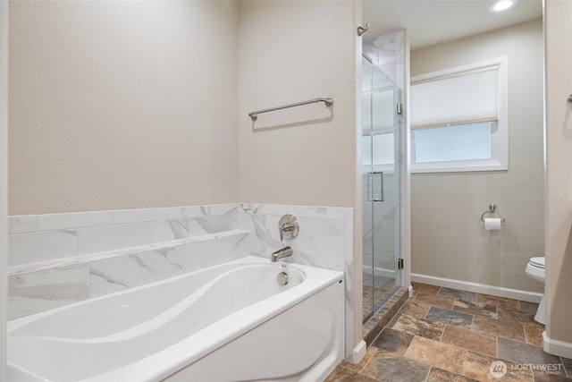 78 Whitten St, Richland, WA 99354 - bathroom featuring stone tile flooring, a stall shower, toilet, a garden tub, and baseboards