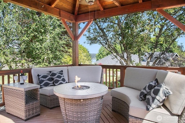 deck featuring an outdoor living space with a fire pit and a gazebo