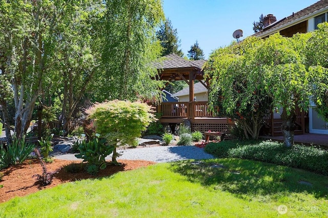 view of grassy yard featuring a wooden deck