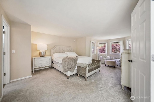carpeted bedroom featuring baseboards