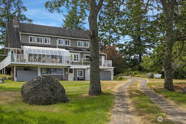 1632 Cattle Point Rd, Friday Harbor, WA 98250 - view of front facade featuring dirt driveway, a chimney, a deck, and an attached garage