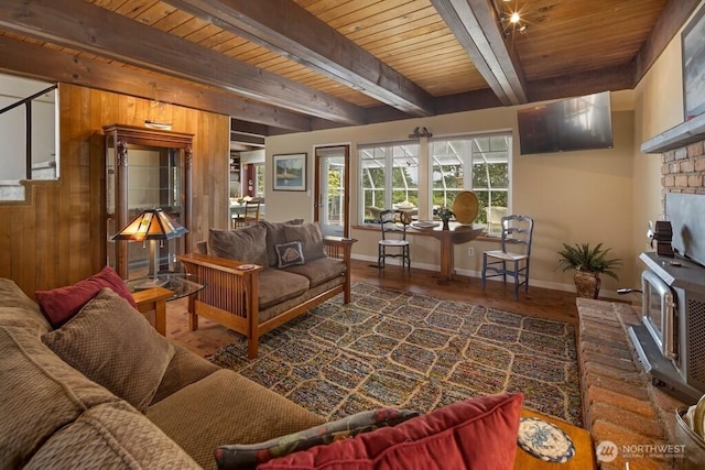 1632 Cattle Point Rd, Friday Harbor, WA 98250 - living area featuring a wooden ceiling with exposed beams, wood finished floors, a brick fireplace, and wood walls