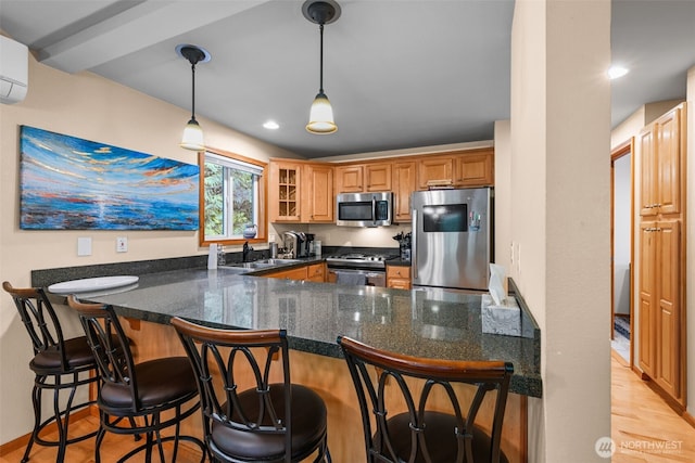 436 E Pointes Dr E, Shelton, WA 98584 - kitchen featuring stainless steel appliances, a peninsula, glass insert cabinets, and decorative light fixtures