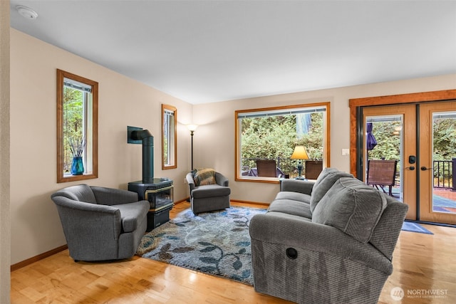 436 E Pointes Dr E, Shelton, WA 98584 - living room with a wood stove, french doors, light wood-style flooring, and baseboards