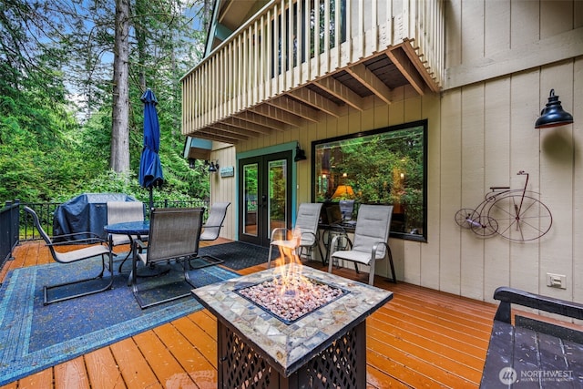 436 E Pointes Dr E, Shelton, WA 98584 - wooden terrace with french doors, an outdoor fire pit, and outdoor dining space